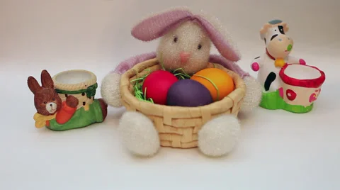 Hand putting Easter eggs in bunny egg holders, bunny basket decoration Stock Footage 35926379