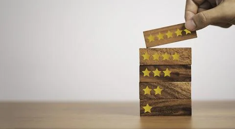 Hand putting five start which print screen on wooden cube block, Stock Photos