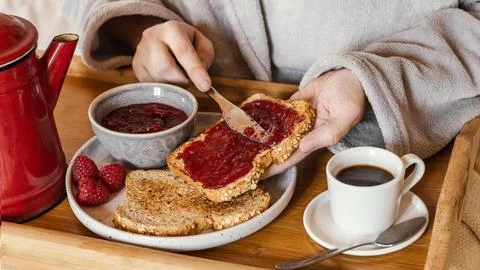 Hand putting jam bread Stock Photos