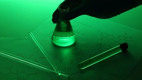 Hand putting laboratory conical flask down on the table Stock Footage 95967606