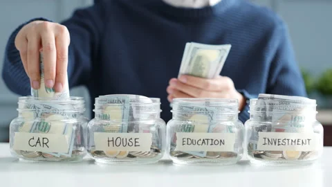 Hand putting money in jar for future, money plan, save money and management Stock Footage 147162128