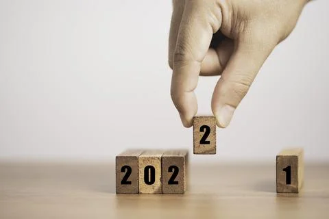 Hand putting number two for replace number one  to change 2021 to 2022 year. Stock Photos
