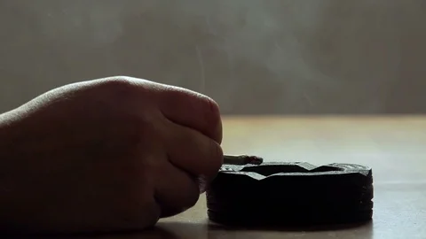 Hand putting out cigarette in ashtray on the table Stock-Footage 74412014