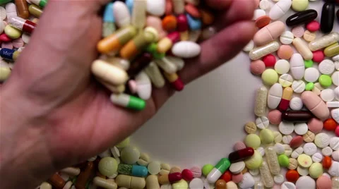 Hand putting pills in circle Stock Footage 6772458