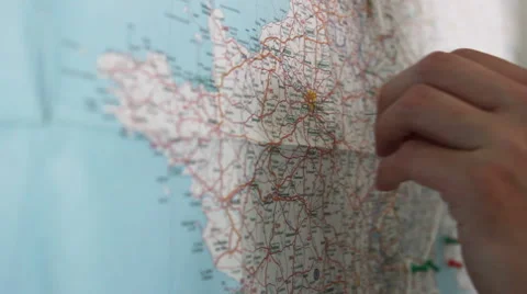 Hand putting a pin on Paris Stock Footage 40624823