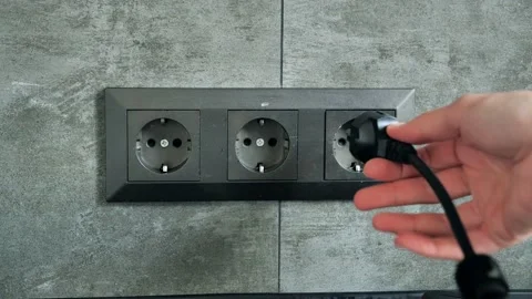 Hand Putting Plug Into Electricity Socket usb device phone cell charge Video stock 132624008