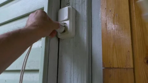 Hand putting plug into electricity socket. Stock Footage 212999257