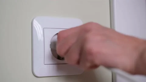 Hand putting plug in electricity socket close up. Stock Footage 226223981