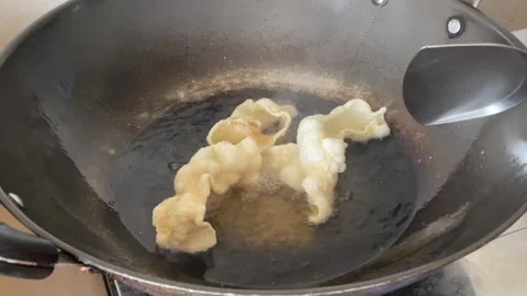 Hand Putting Prawn Crackers Into Hot Oil Expanding And Scooping Out Stock Footage 334365295