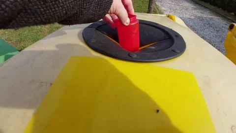 Hand Putting a Red Plastic Bottle into a Yellow Recycling Bin Stock Footage 333644209