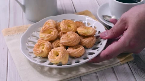 Hand putting Samantas on the table, typical brazilian sugar covered biscuit Stock Footage 302303588