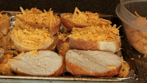 Hand putting shreeded cheese on buns Stock Footage 92919915