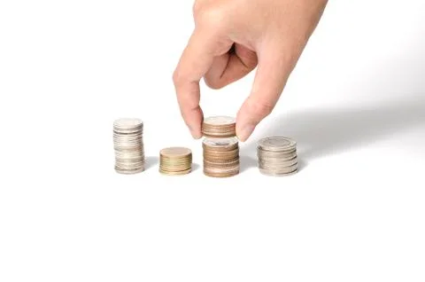 Hand putting stack of coins Stock Photos