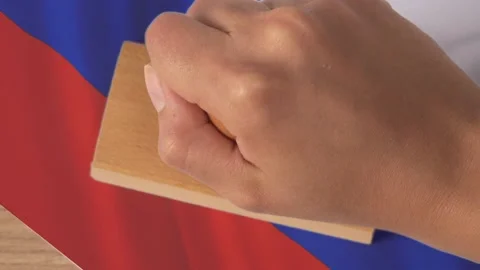 Hand putting stamp sanctions on Russian national flag Stock Footage 170903614