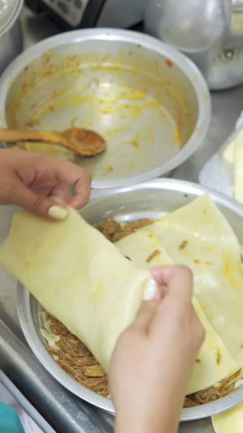 Hand putting thin dough Видео 246241612