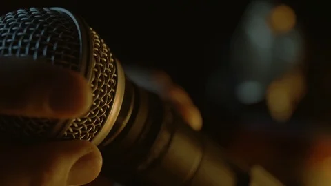 A hand is putting together a dynamic microphone. Stock Footage 116846135