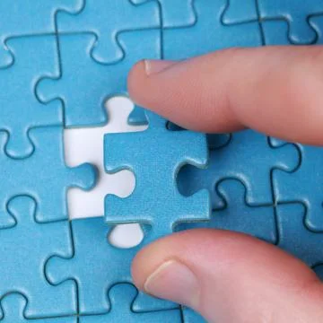 Hand with puzzle Stock Photos