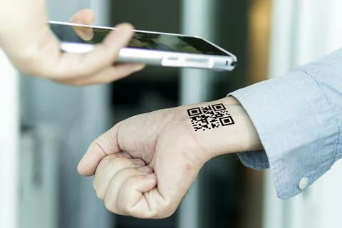 Hand with qr code on wrist. Future of political population control. Chipizati 库存照片