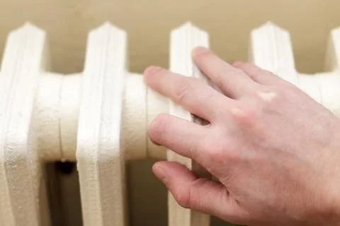 Hand on radiator Stock Photos