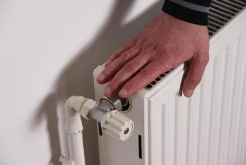 Hand on the radiator Foto stock