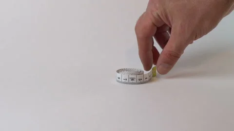 Hand raises a measuring tape Stock Footage 126805237