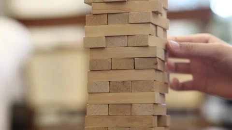 A hand reaches down to move a chess piece on a board Stock Footage 278886592