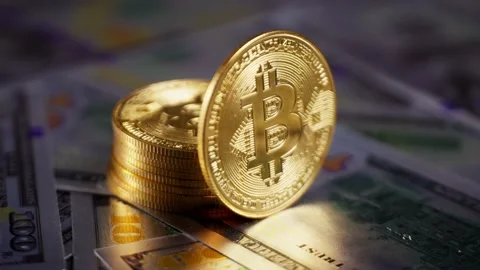 Hand reaching for a Bitcoin coin from a stack of cryptocurrency coins and Stock Footage 312328756