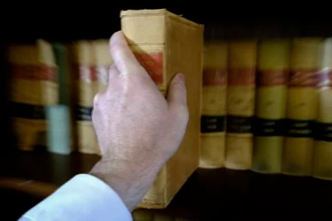 Hand Reaching for Book Pulling Off Shelf Stock Photos