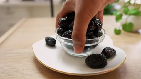 Hand Reaching for a Date from a Bowl Stock Footage 320727873