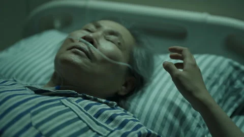 Hand reaching for a dying elderly patient in hospital bed Stock Footage 333800748