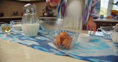 Hand reaching for eggs on kitchen table Stock Footage 318171964