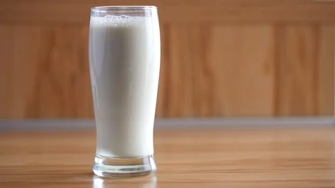 Hand reaching for a glass of milk Stock Footage 88411892