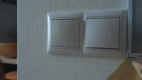A Hand Reaching for the Light Switch in a Modern Interior Space Vidéo 303829097