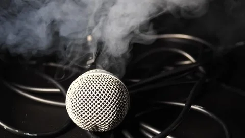 Hand reaching for microphone picking it up ready to sing with smoke close up Stock Footage 204062903