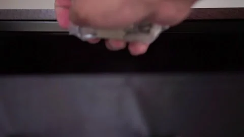 Hand reaching to open fabric drawer using wooden handle to take something. Vidéo 341457332