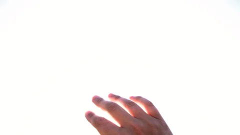 Hand reaching out to the sun in slow motion Stock Footage