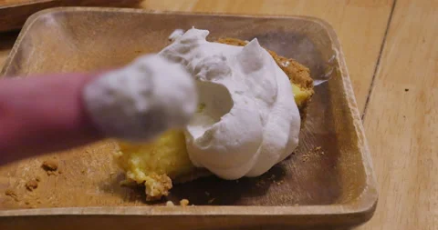 Hand reaching for a slice of tart with whipped cream Video stock 152367256