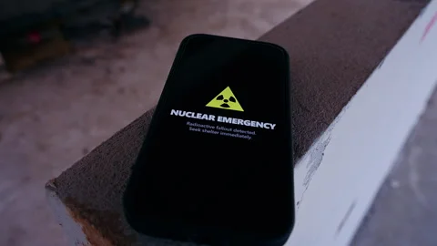 Hand Reaching For Smartphone Showing Nuclear Emergency Alert With Radiation Warn Video stock 330571052