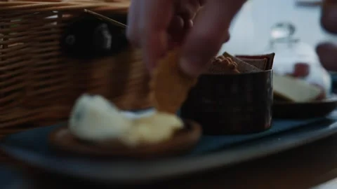 A hand is reaching for a snack in a basket Stock Footage 295995791