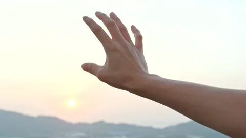 Hand Reaching for Sun Over Mountain Landscape Stock Footage 346026075