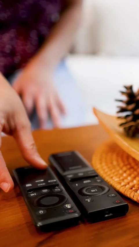 Hand Reaching for Television Remote Control on Wooden Coffee Table Stock Footage 333164954