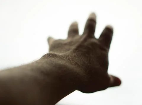 Hand reaching toward light, background removed Stock Photos
