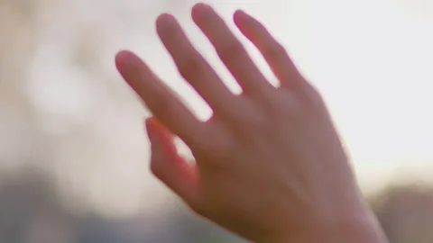 Hand Reaching Towards Bright Sunlight With Lens Flare 库存影片 334840650