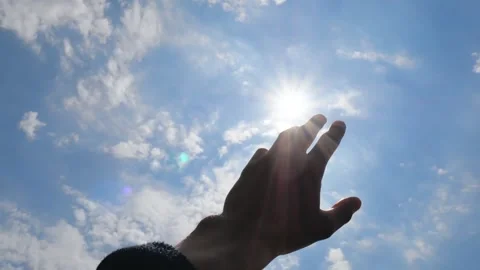 Hand Reaching Towards the Sun in Blue Sky Stock Footage 346029107