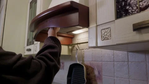 Hand reaching to turn off kitchen range hood ventilation Video stock 342089628