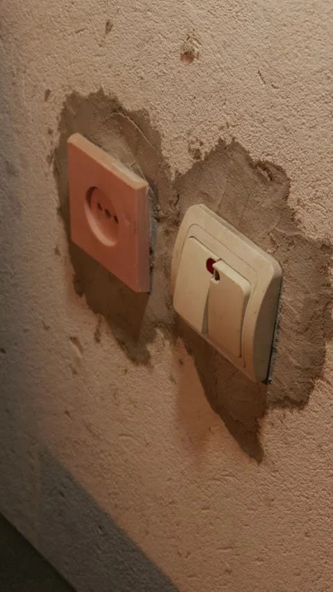 Hand Reaching to Turn on Light Switch on Rough Plastered Wall Video stock 335639717