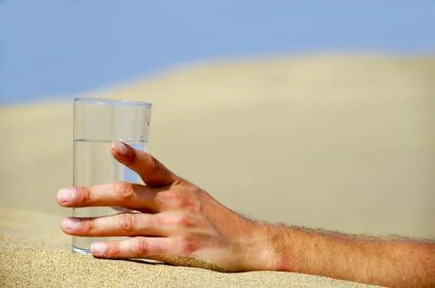 Hand reaching for water. Stock Photos