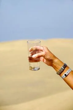 Hand reaching for water. Stock Photos