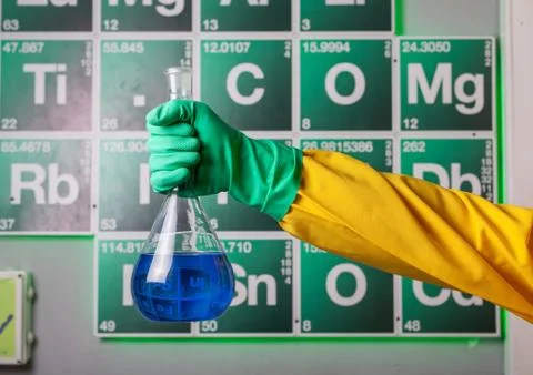Hand with reagent in the flask 写真素材