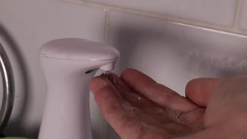 Hand receiving liquid soap from automatic dispenser, hygiene and care refle.. Stock Footage 319825627